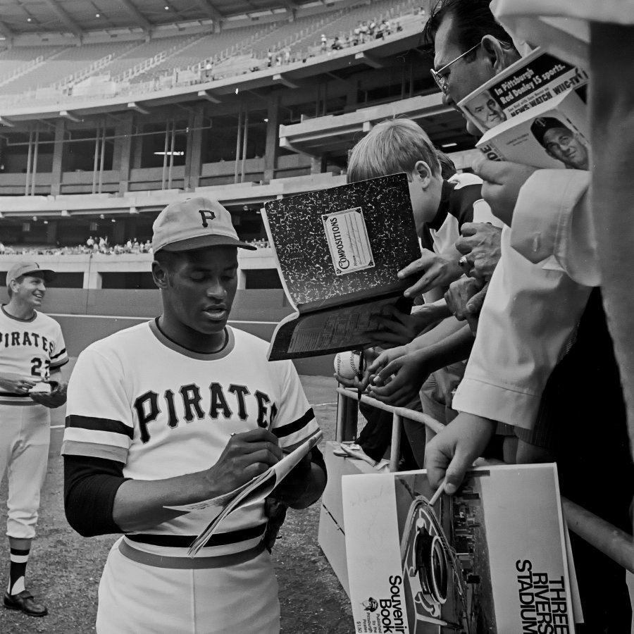 Roberto Clemente signing autographs.