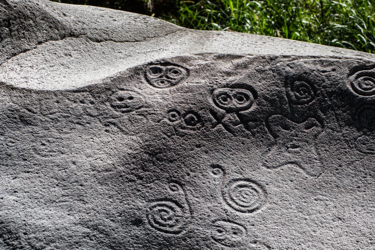 Ancient petroglyphs carved into a rock in Jayuya, Puerto Rico