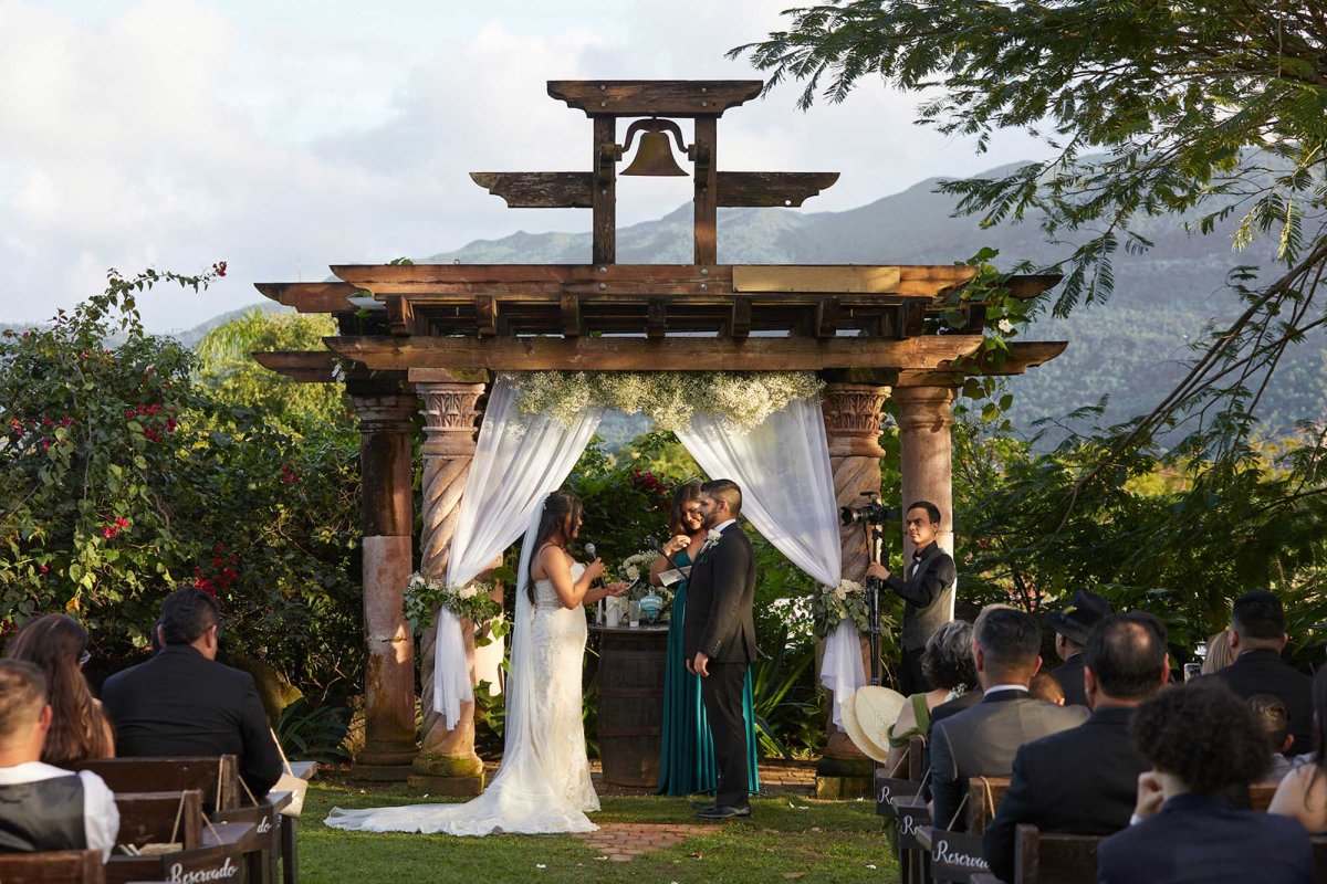 A couple gets married in front of a beautiful mountain backdrop in Puerto Rico.