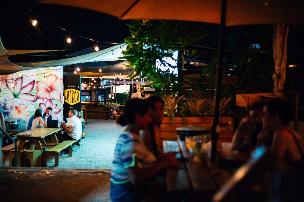 Diners sit at outdoor tables at Lote 23, a food truck park in the Santurce neighborhood of San Juan, Puerto Rico.