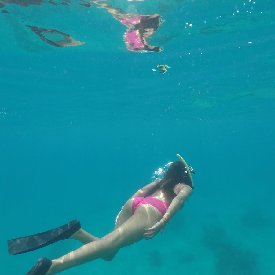 A girl snorkels beneath the water in Puerto Rico.