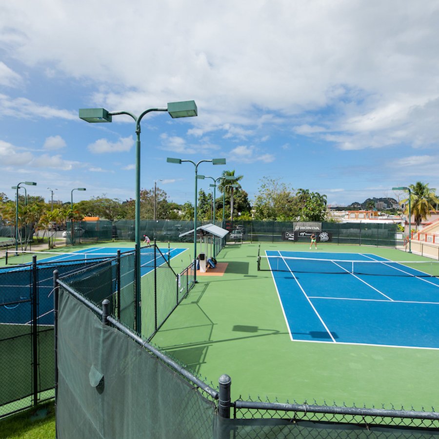 Two women competing in a singles tennis match at Honda Tennis Center in Bayamón, Puerto Rico.