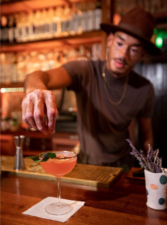 A bartender puts the finishing touches on a cocktail at a bar in Puerto Rico.