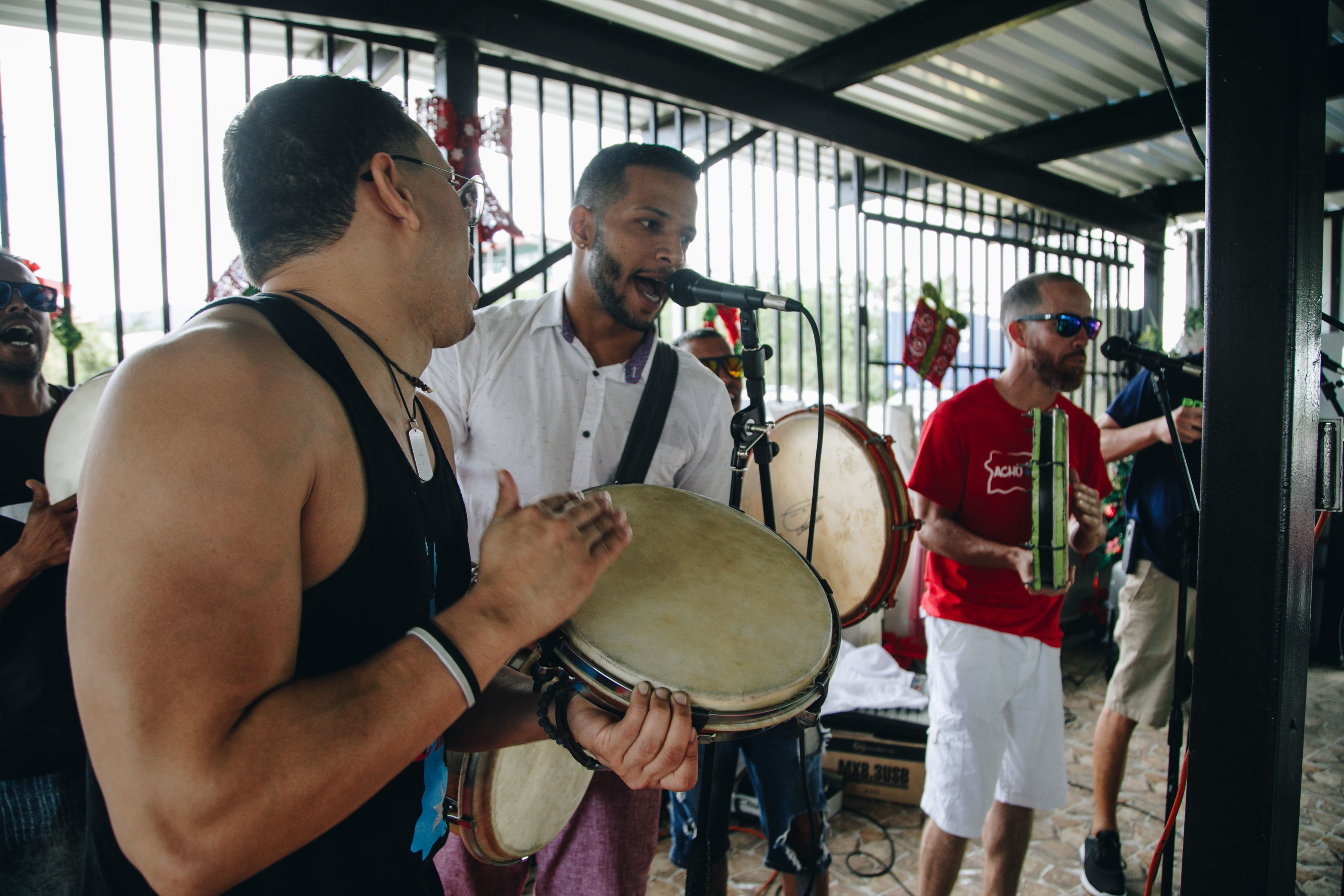 Three musicians perform Puerto Rican music.