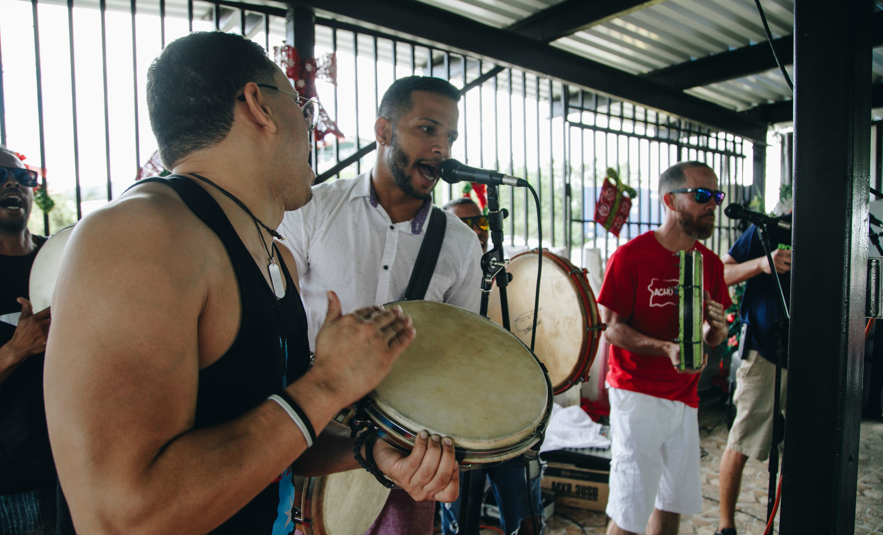 A three-person Puerto Rican band performs.