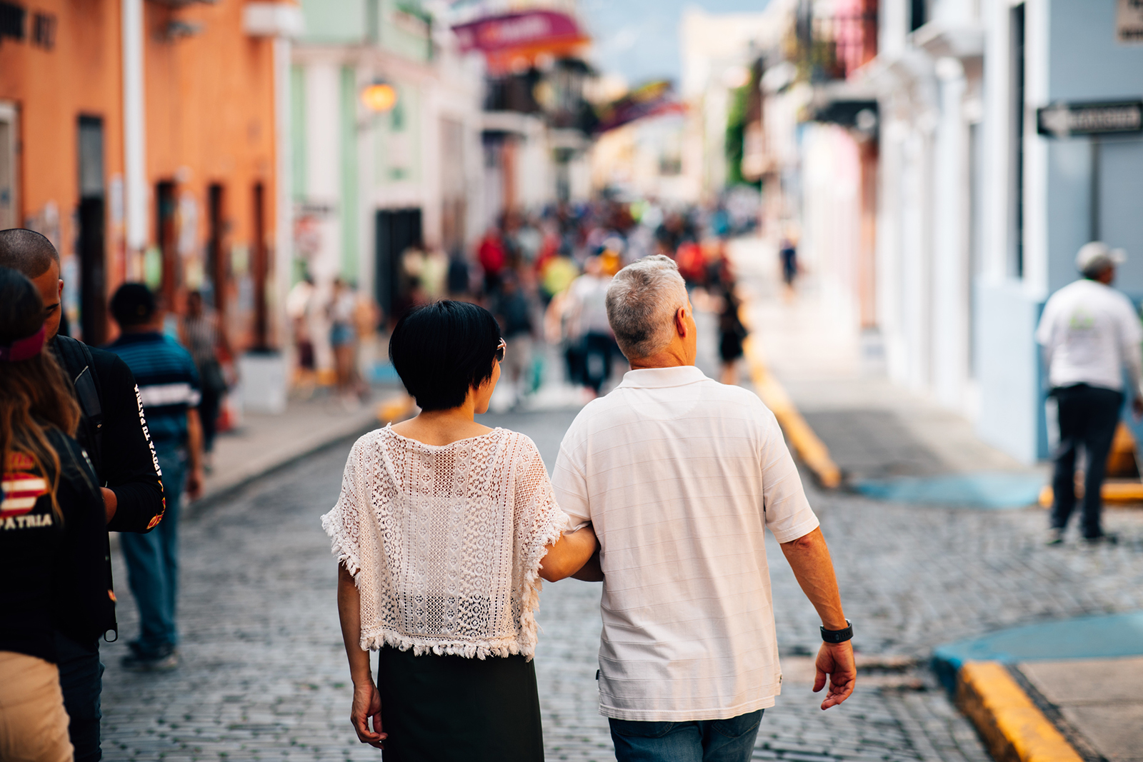 A couple enjoys a stroll through the cobblestone streets of Old San Juan.