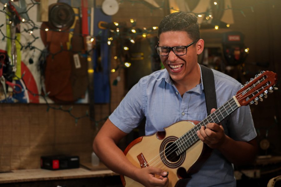 a man playing the cuatro, Puerto Rico's national instrument. 