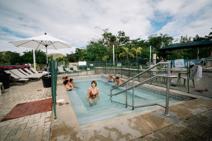 A woman gets out of the hot spring pool