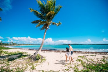 A couple strolling through the stunning Esperanza beach in Vieques.