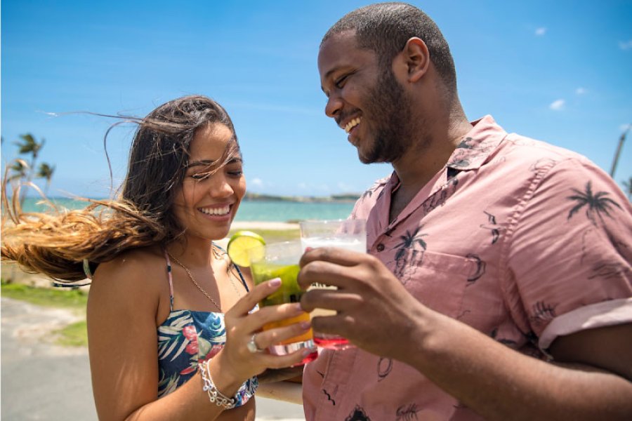 Couple toasting cocktails at Casa BACARDÍ near San Juan