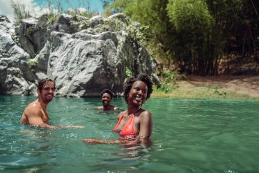 a family enjoys the river in Puerto Rico