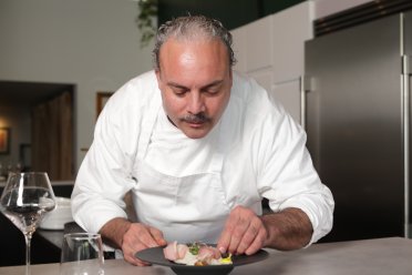 The chef at Epicuro prepares a plate