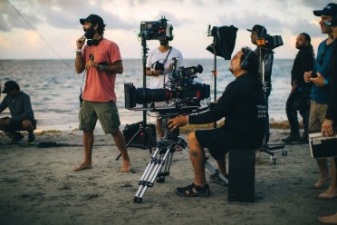 Film crew in the beach.