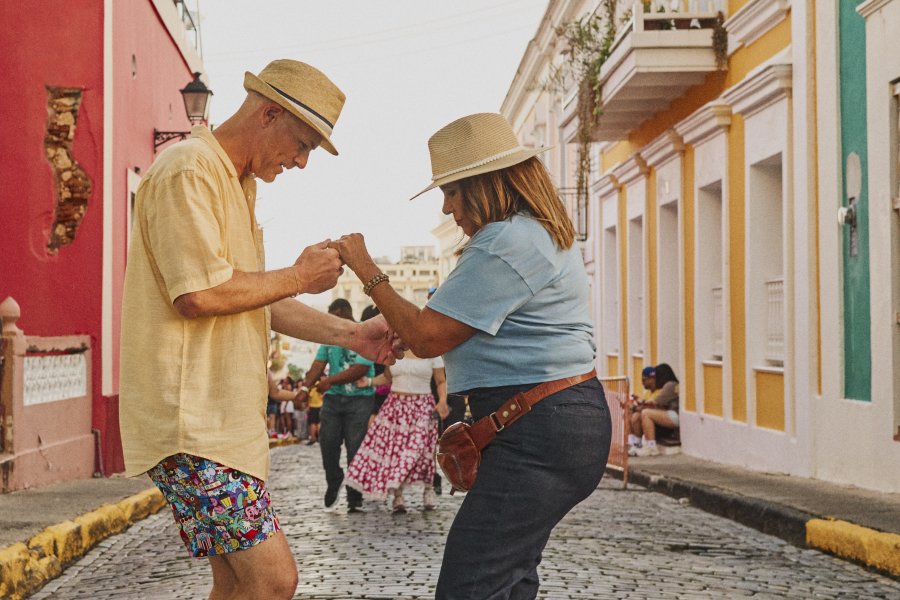 Two people dancing Salsa in the middle of the streets at the Old San Juan streets.