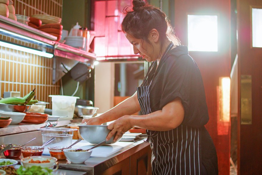 Chef from Cocina al Fondo prepares ingredients inside the restaurant kitchen in Puerto Rico.