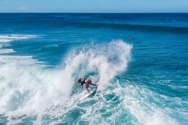 A surfer carves through a beautiful wave in Rincón, the heart of Puerto Rico surfing.