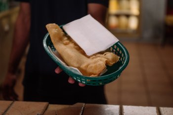 A server at Pastelillos Lamboy in Manati holds out a basket of pastelillos.