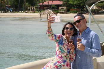 Couple taking a selfie in front of the beach in Copamarina Resort in Guanica