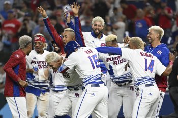Group of baseball players with dyed blonde hair celebrating.