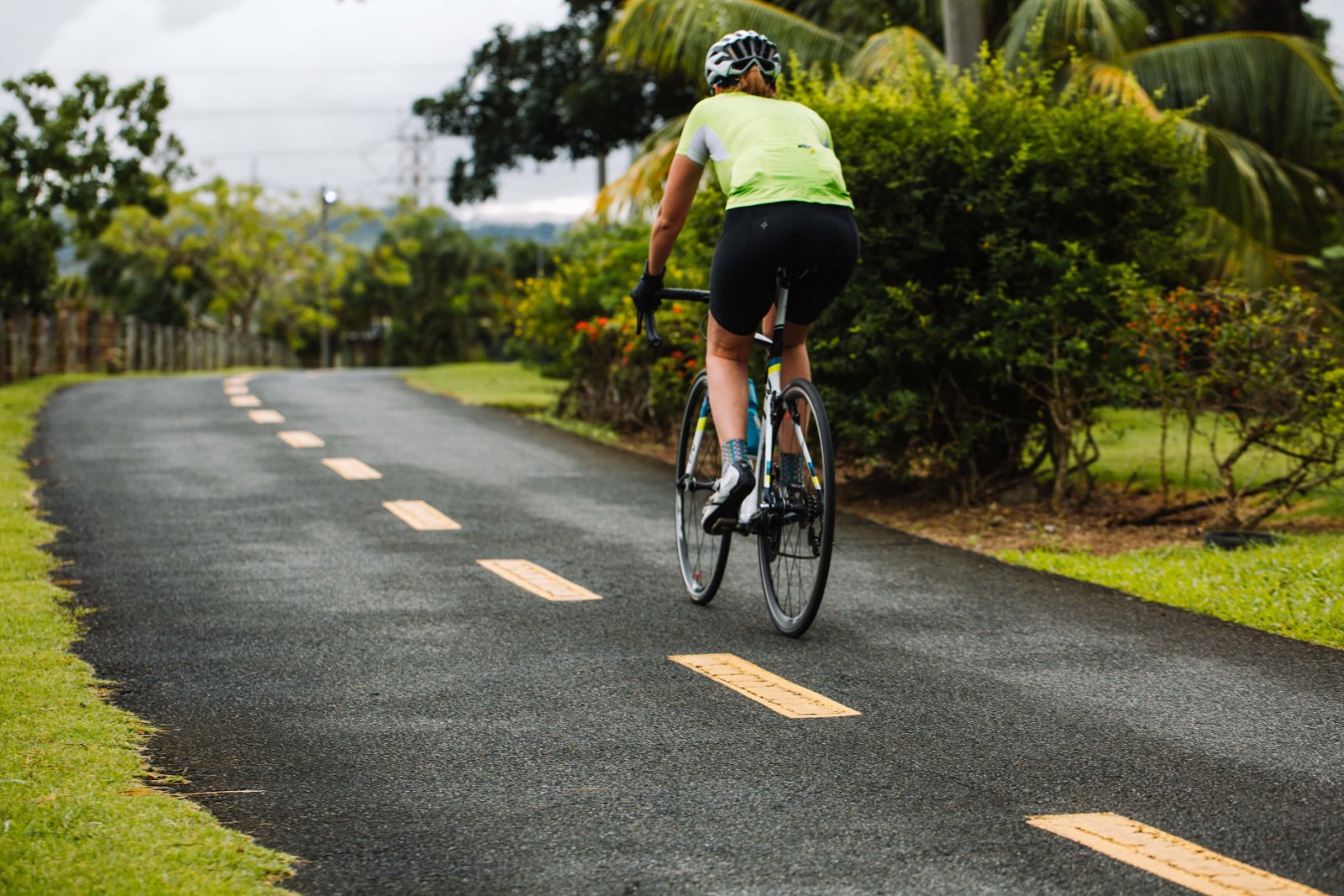 Biker biking along a scenic pathway in Paseo Lineal, Bayamón's Central Park.
