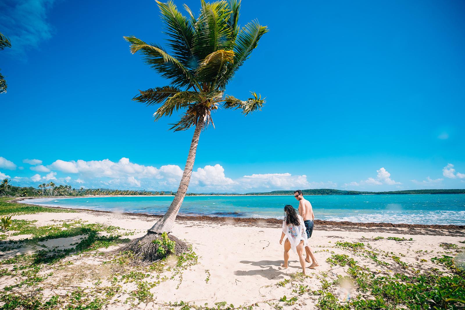 A couple strolling through the stunning Esperanza beach in Vieques.