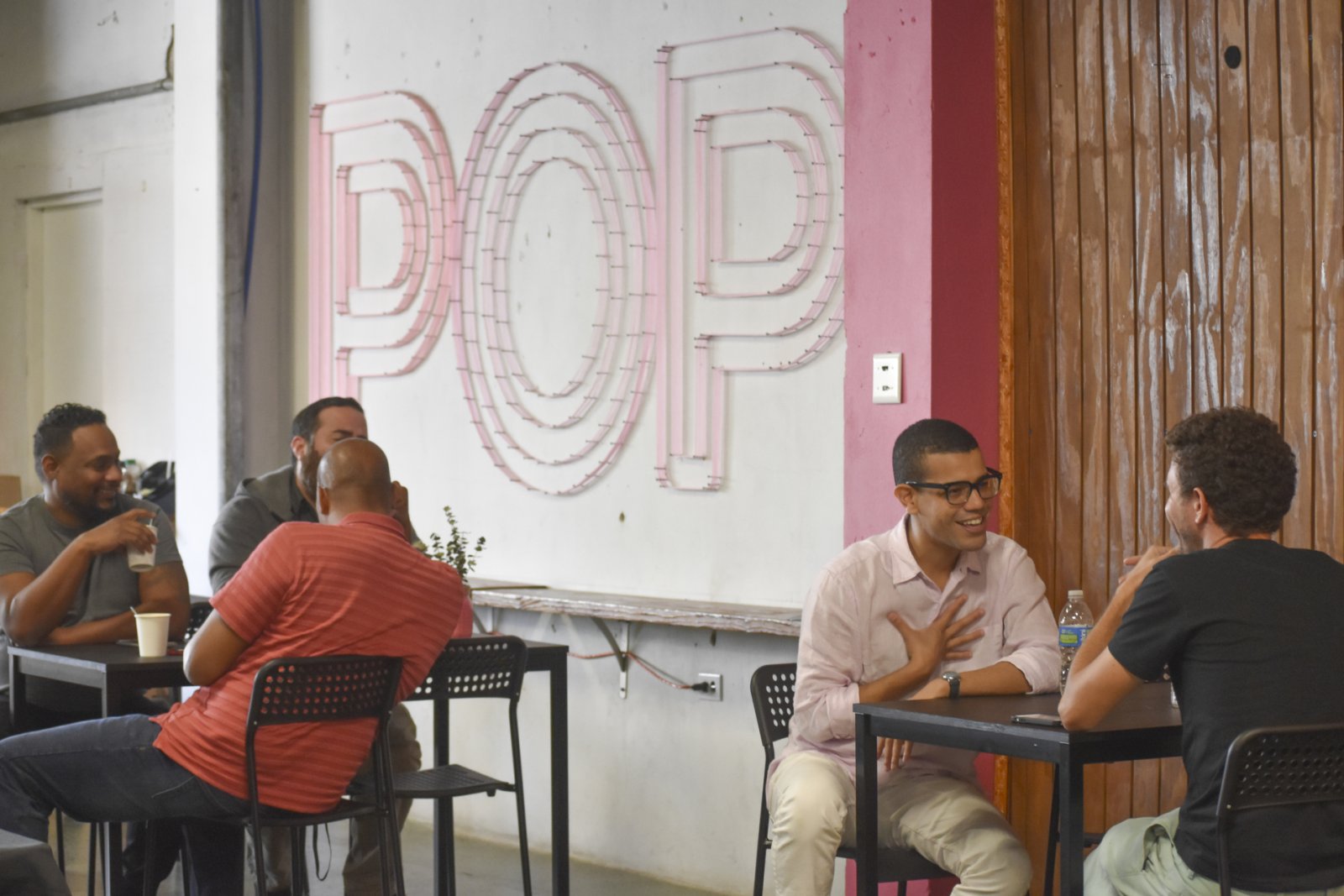 people sitting at tables and talking in POP in Santurce