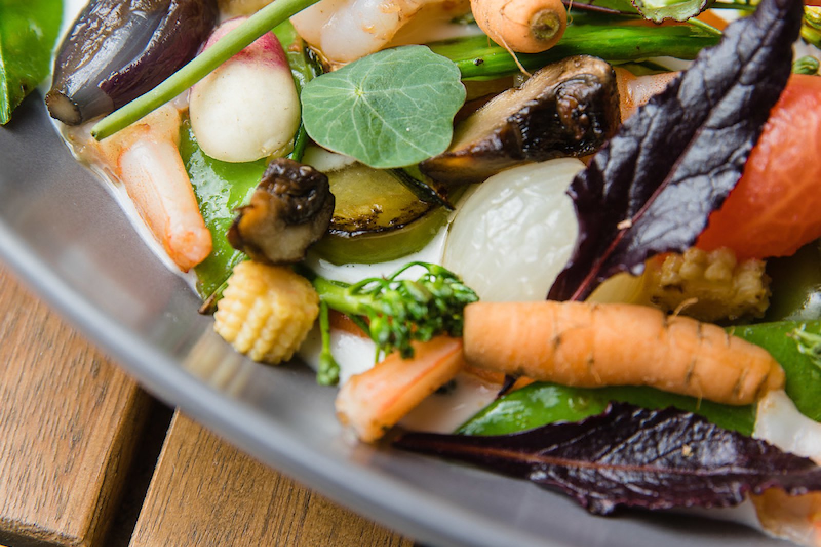 A plate with a spring salad from a vegan restaurant.