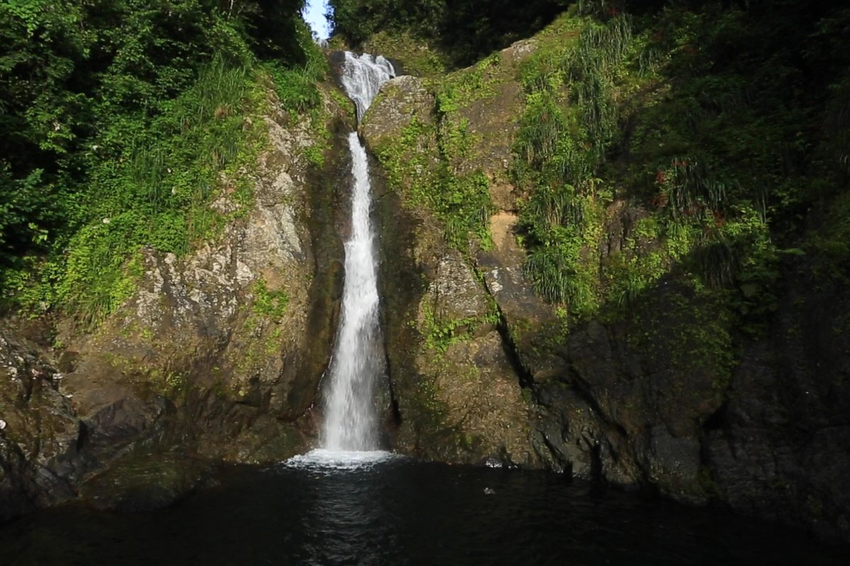 Dona Juana waterfall cascading into the lake below.