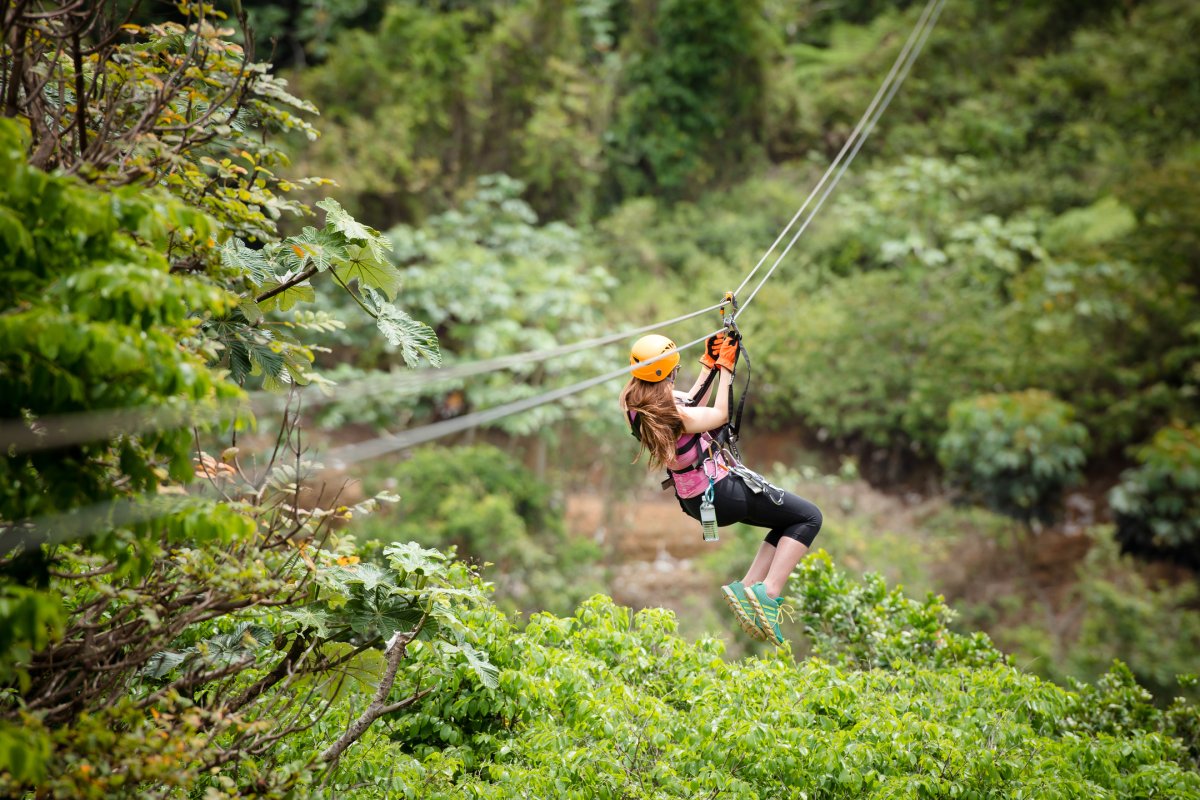 Una mujer vuela por una tirolesa en Toro Verde Adventure Park.