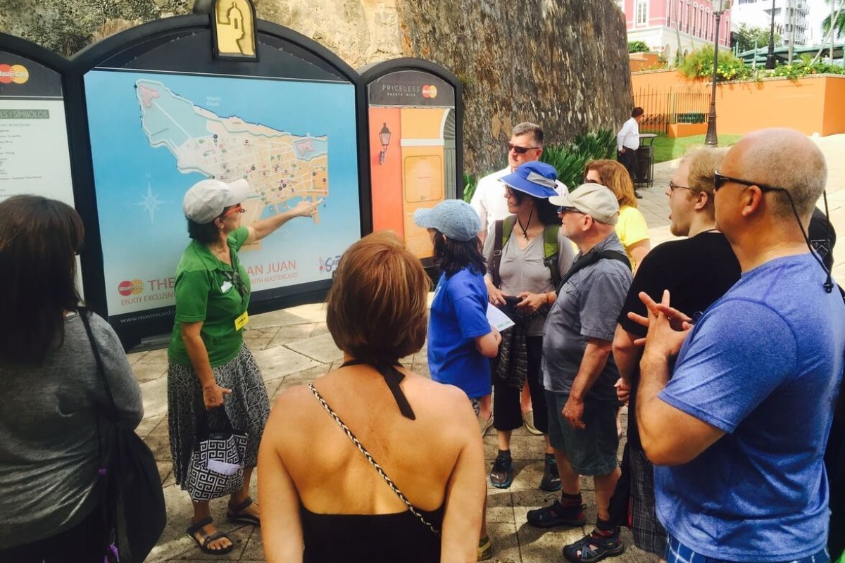 Flavors of San Juan walking tour admiring informational sign. 