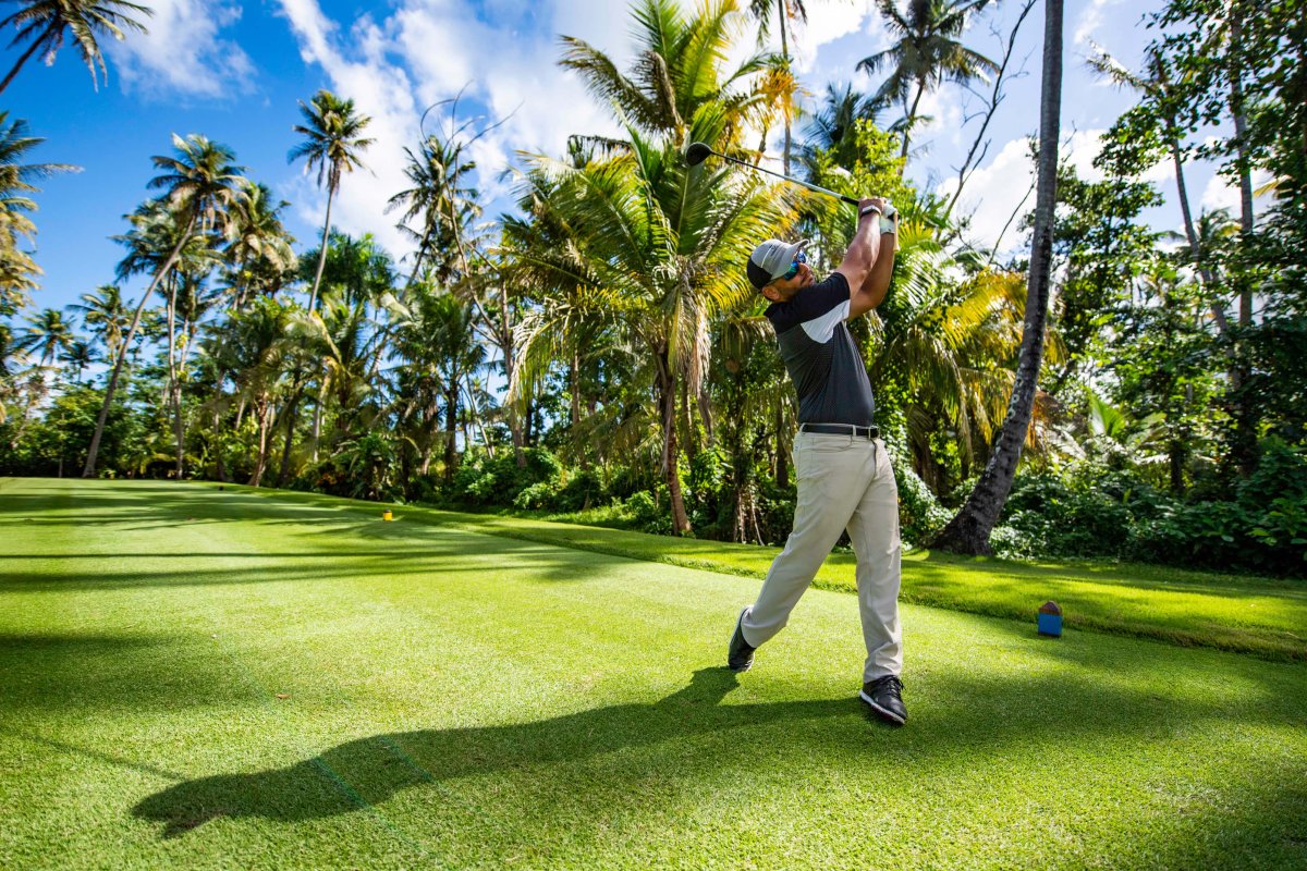 A golfer plays one of the three scenic golf courses at Dorado Beach, a Ritz-Carlton Reserve.