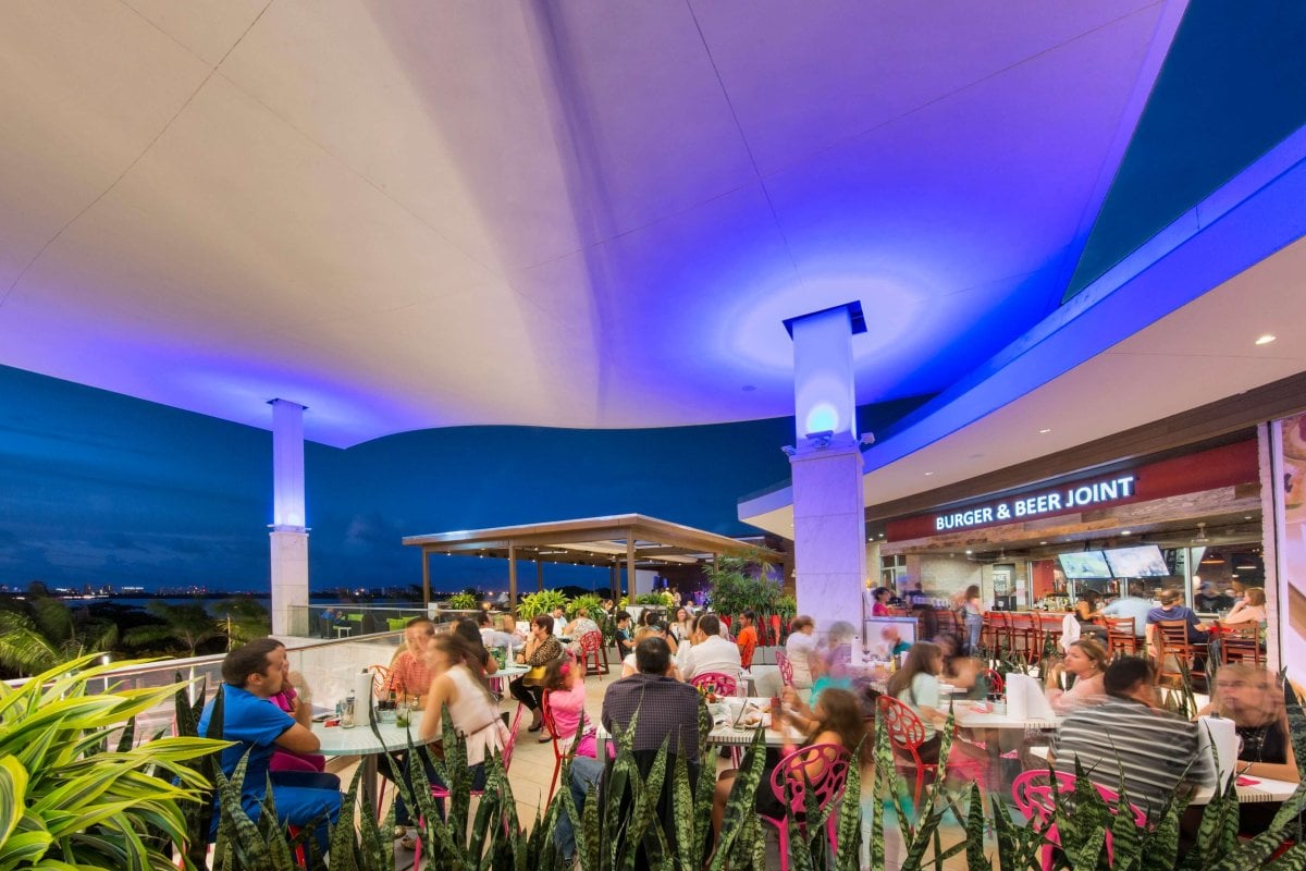 Several shoppers enjoying a relaxing evening on the terrace in the Mall of San Juan.