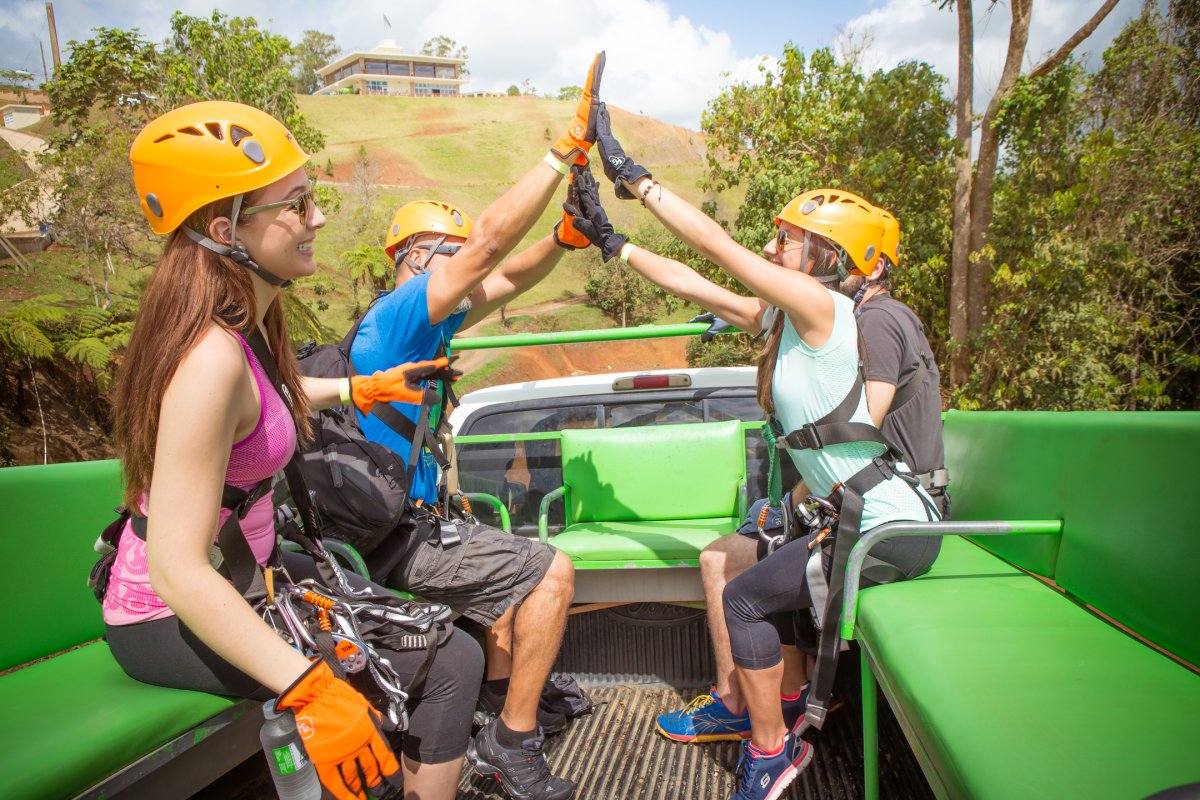A group high-fives after an activity at Toro Verde Nature Adventure Park.