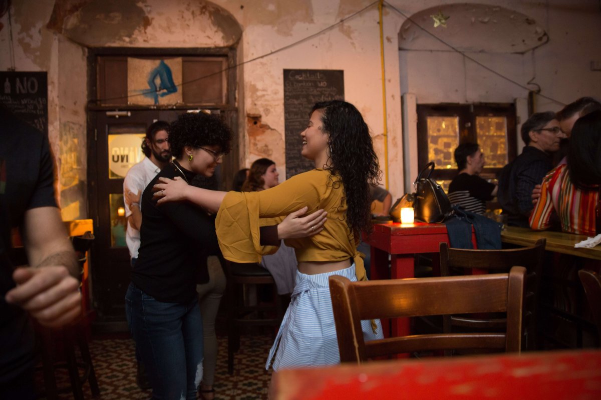 Two people practice dancing together.