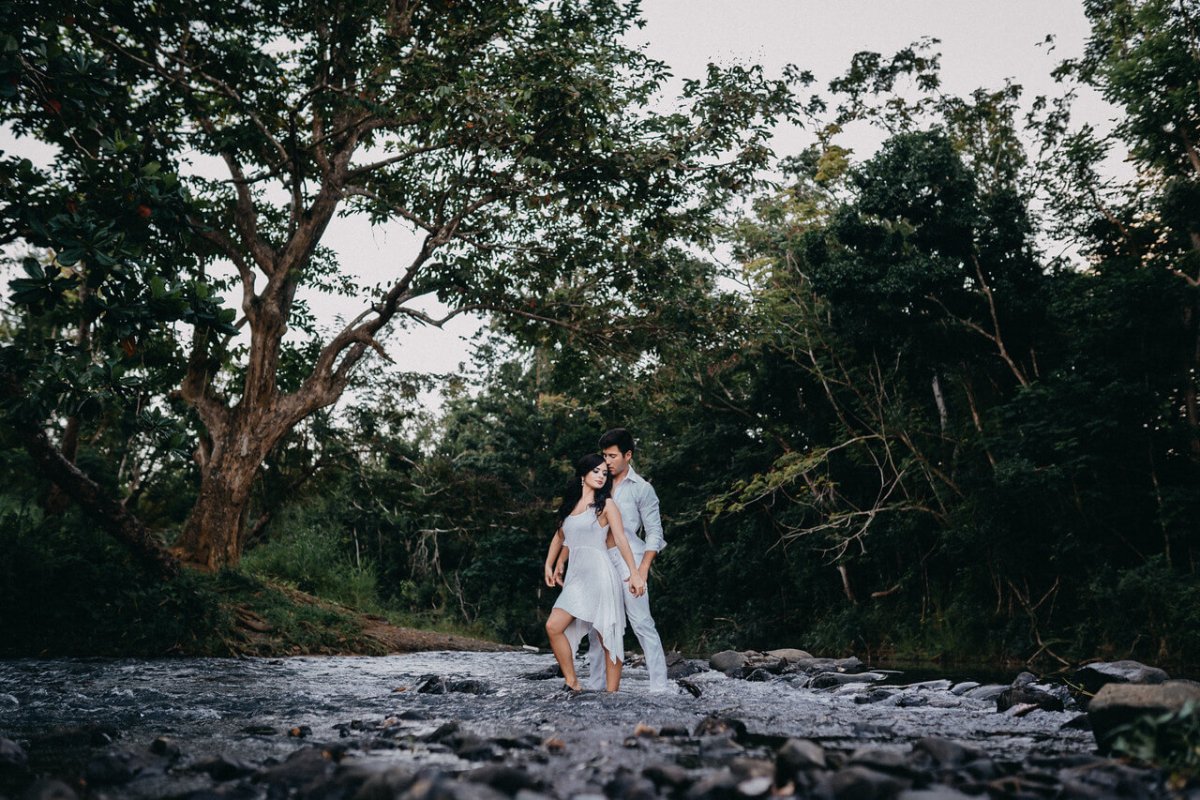 Couple standing in the river at Hacienda Siesta Alegre.