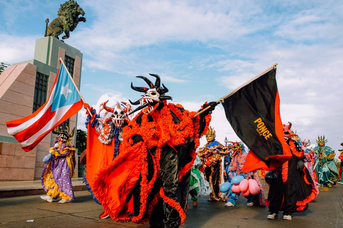 Revelers in traditional vejigante costumes at Carnaval Ponceño.