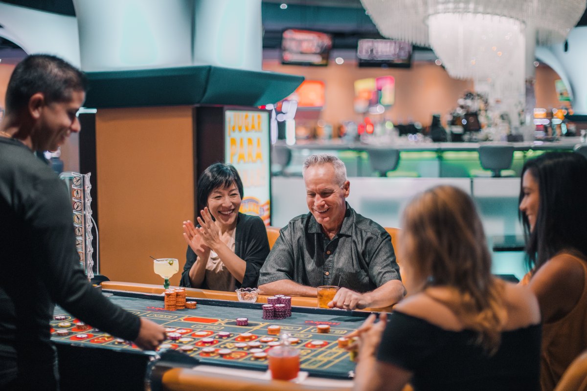 A couple celebrates their win at a casino table