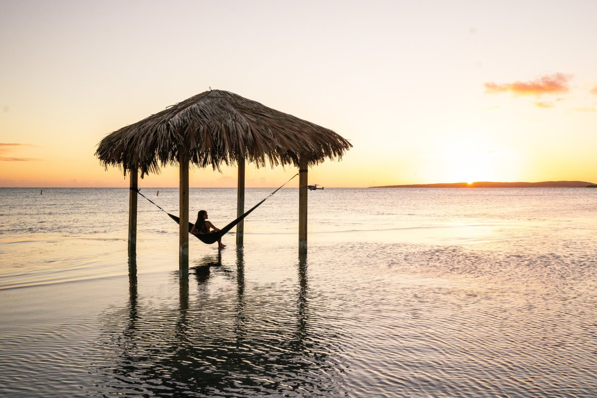 A woman relaxes in an overwater hammock at Copamarina Resort in Guánica.