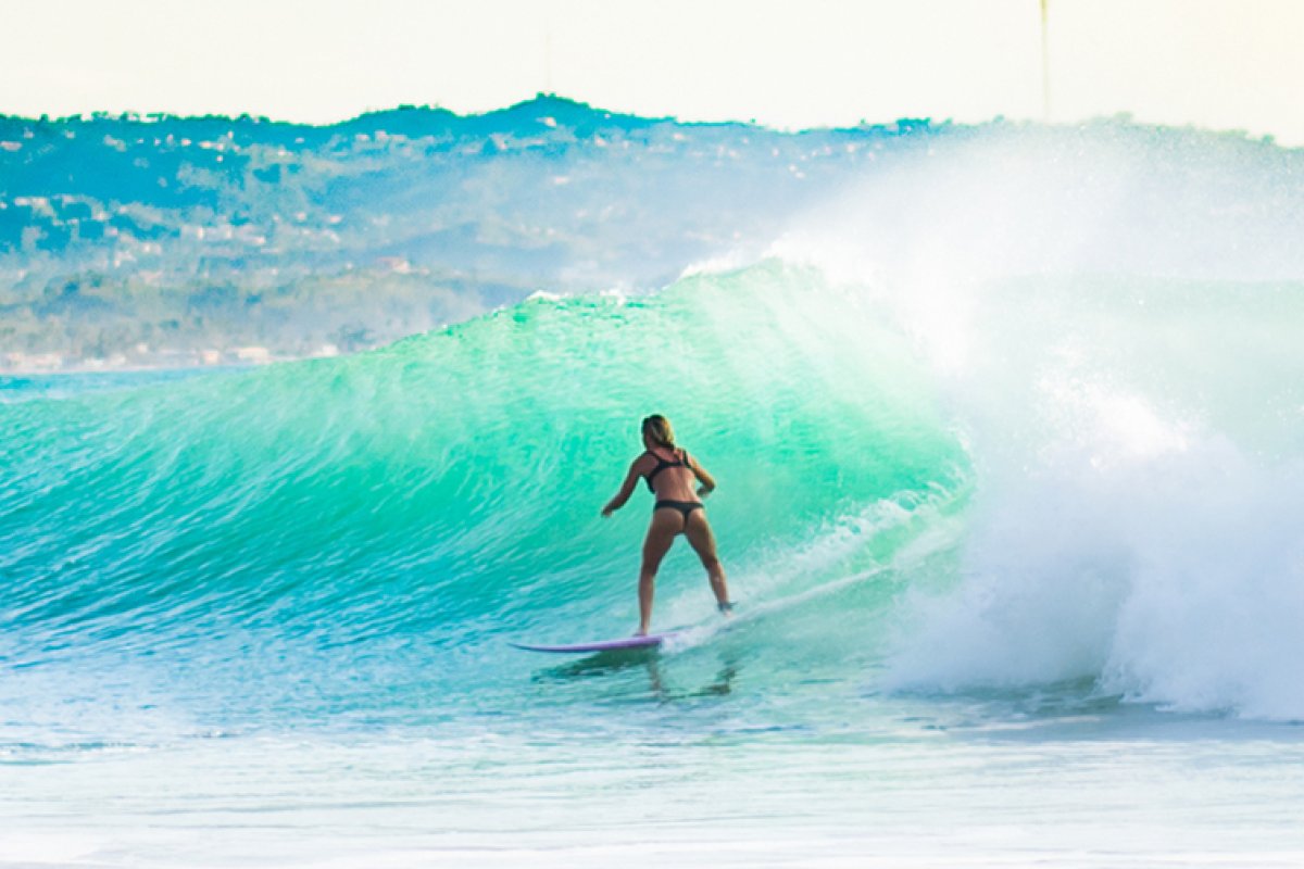 A surfer takes a wave in Crash Boat Beach, Aguadilla.