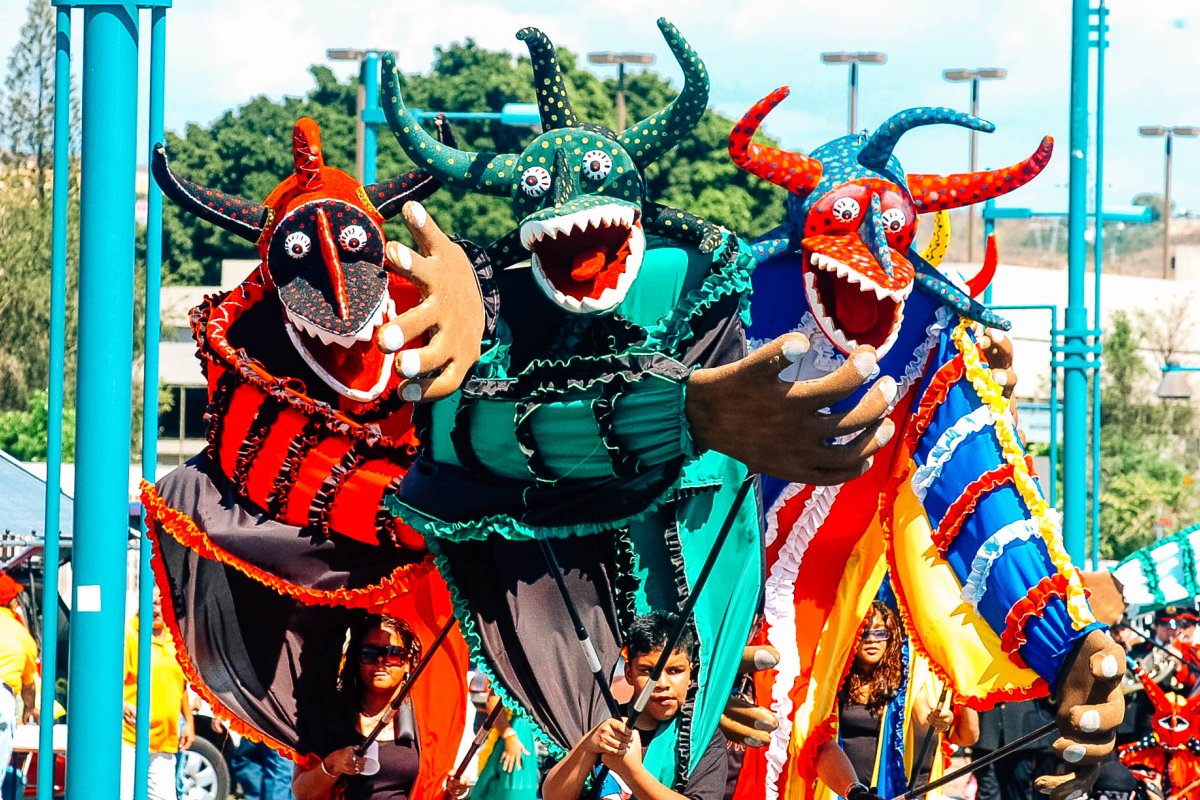 A group of large, colorful puppets in a carnaval parade in Ponce.