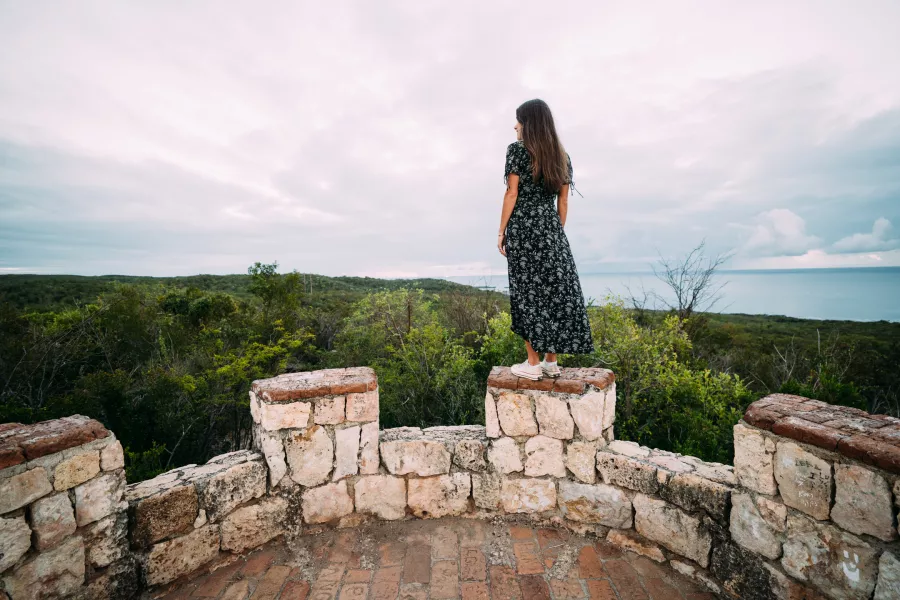 Hiker overlooking Guánica Dry Forest from Fuerte Caprón, one of the top hikes in Puerto Rico.