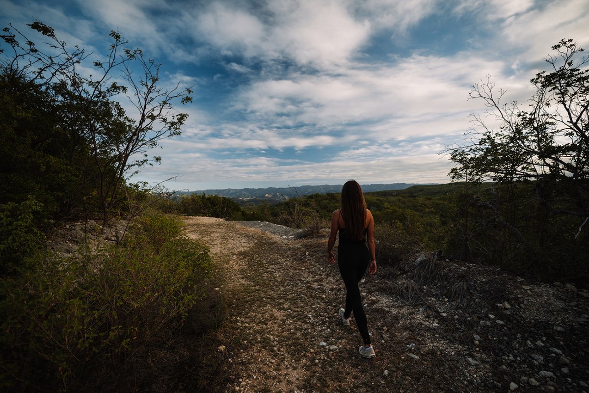 Woman walking through the Guánica Dry Forest.