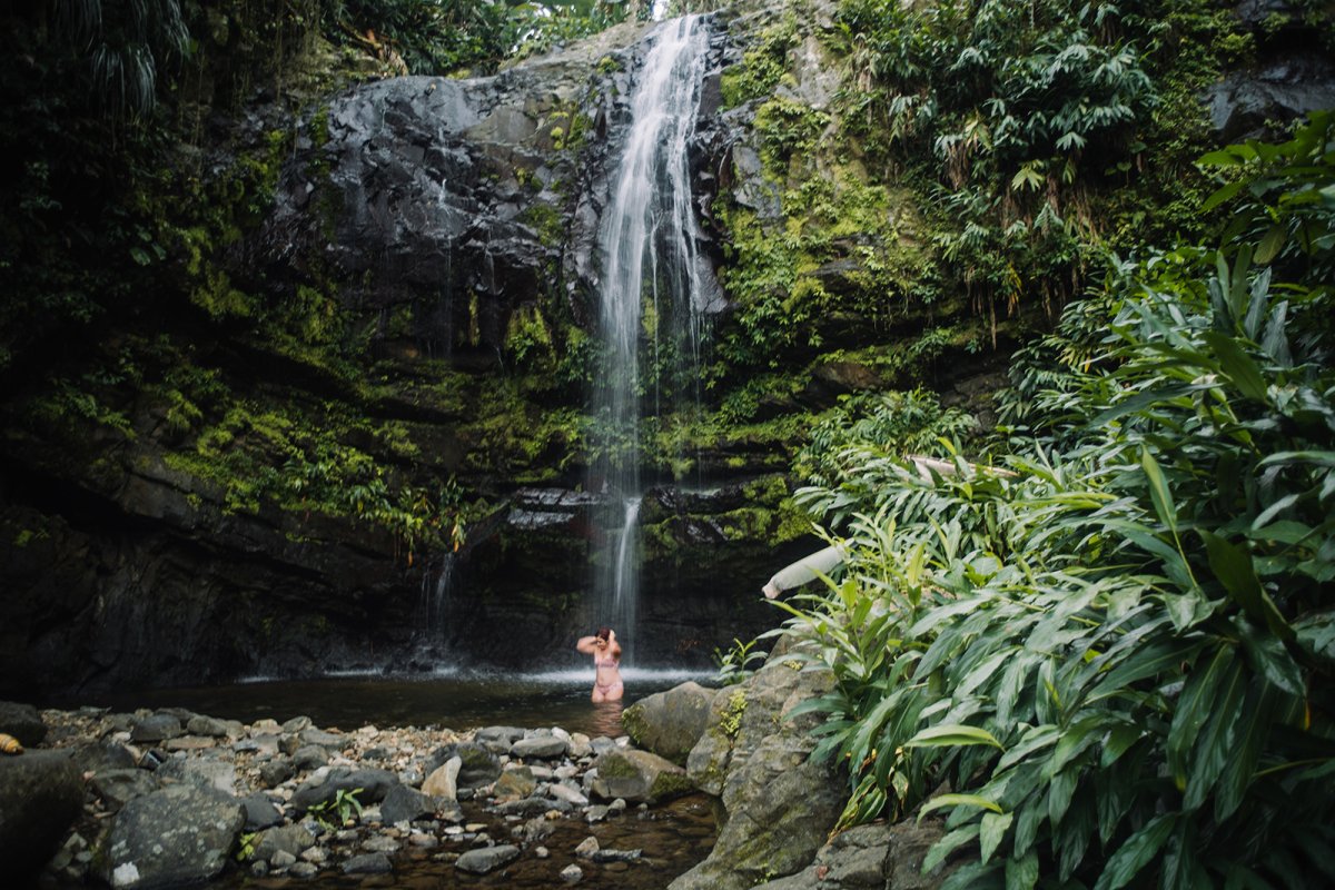 Woman enjoys the waterfall at Las Delicias in Ciales 