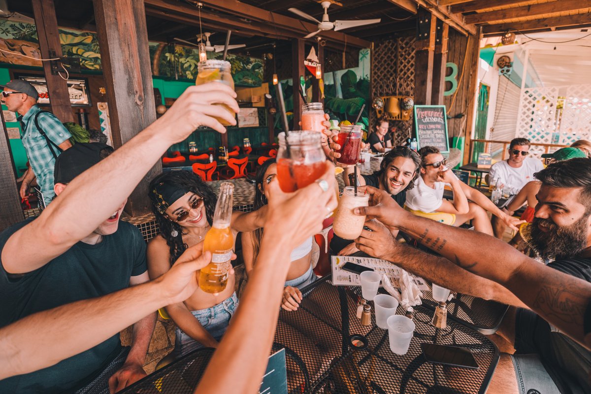 A group of friends raises their glasses for a toast