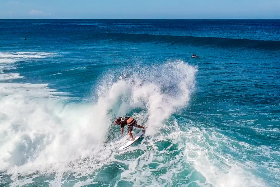 A surfer carves through a beautiful wave in Rincón, the heart of Puerto Rico surfing.