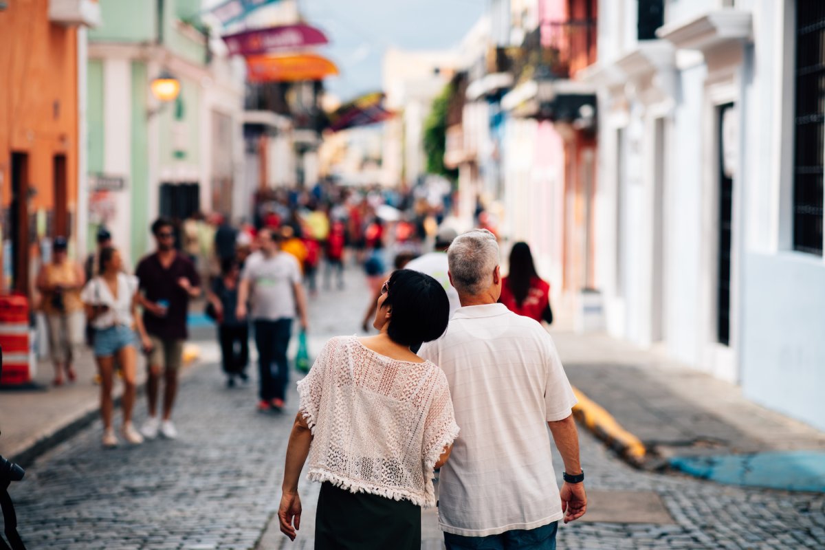 A couple strolls down San Juan's historic cobblestone streets.