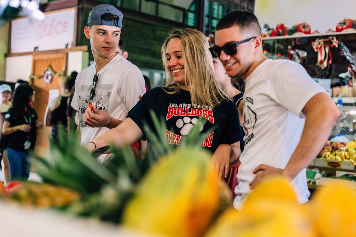 Youth groups exploring a local food market.