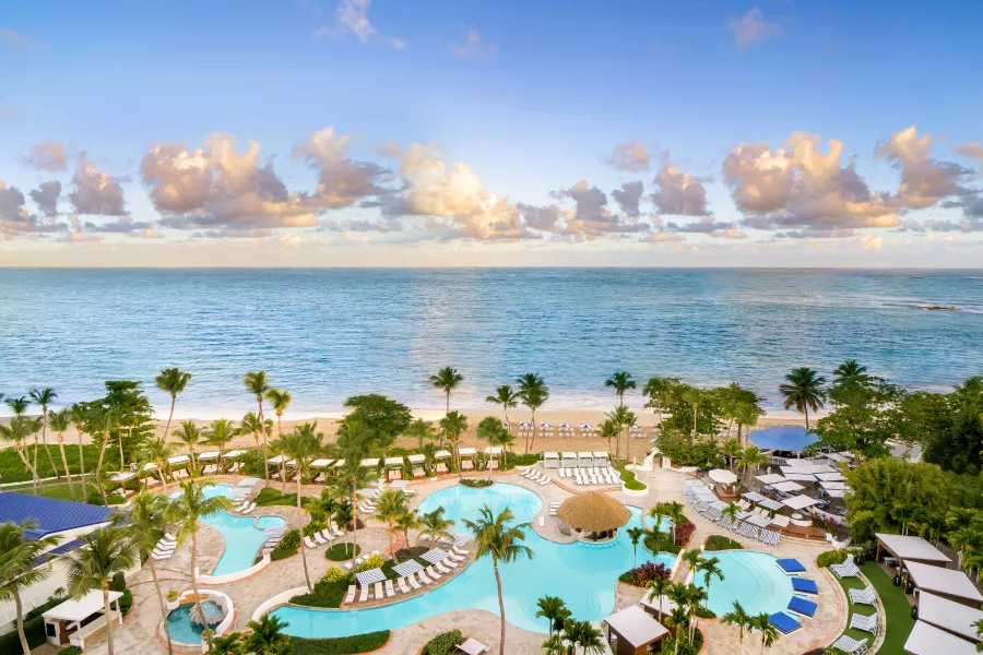 Stylish pool scene at Fairmont El San Juan, a historic favorite among the best Puerto Rico resorts.