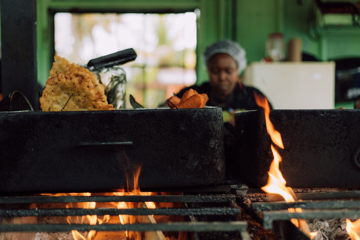 A woman serves Puerto Rican fritters
