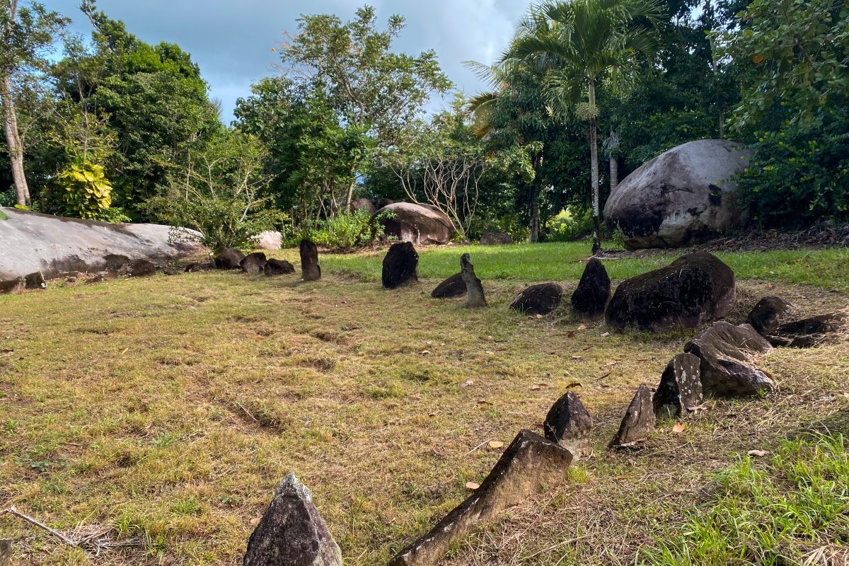 Rocks in various sizes and shapes are lines next to each other to form a ceremonial indigenous plaza known as a batey.